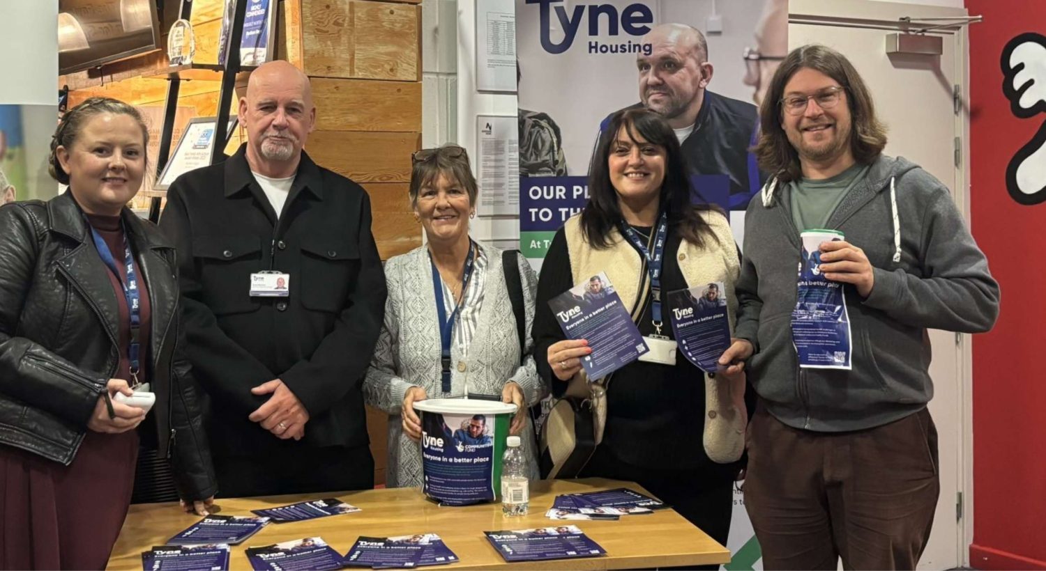 Tyne Housing representatives standing together at an information stall.